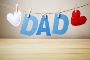 DAD text and felt hearts with stitches hanging on a string